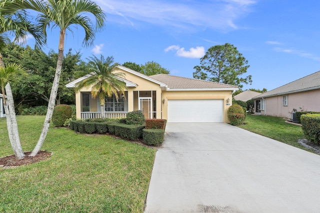 view of front of property with a front yard and a garage