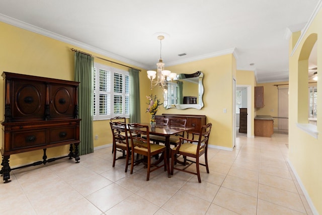 tiled dining area featuring crown molding and a chandelier