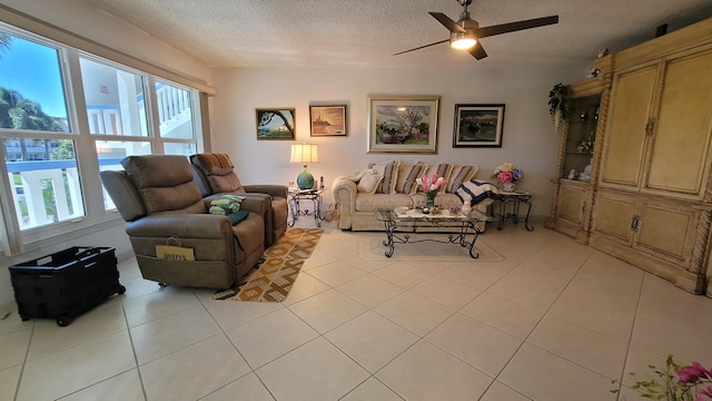 tiled living room with ceiling fan and a textured ceiling