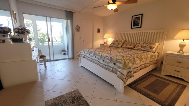 bedroom featuring access to exterior, ceiling fan, and light tile floors