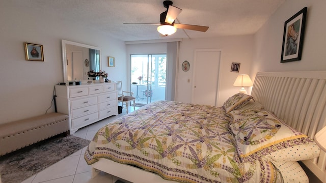 tiled bedroom featuring ceiling fan