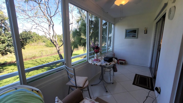 sunroom with a healthy amount of sunlight and ceiling fan