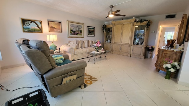 tiled living room featuring a textured ceiling and ceiling fan