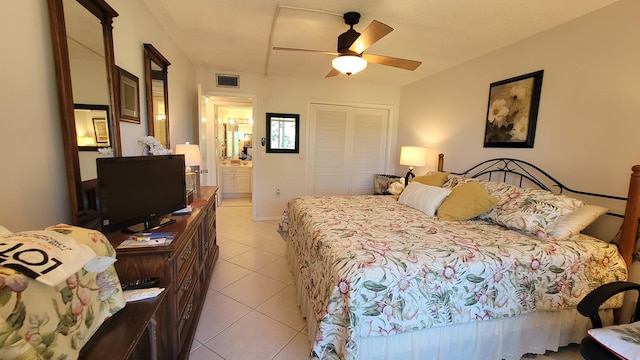 bedroom with ensuite bathroom, a closet, ceiling fan, and light tile floors