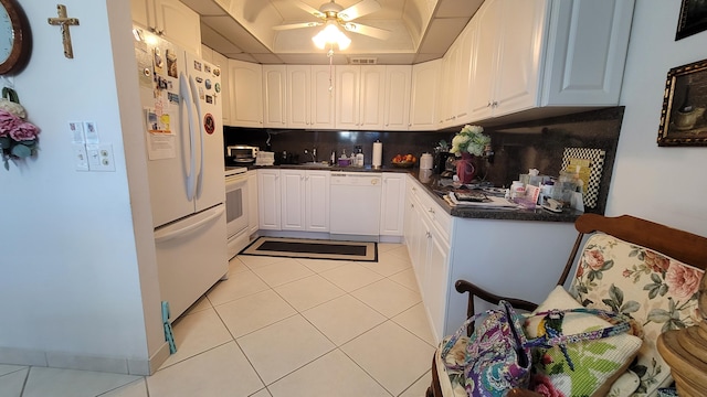 kitchen featuring ceiling fan, white appliances, light tile floors, white cabinets, and tasteful backsplash