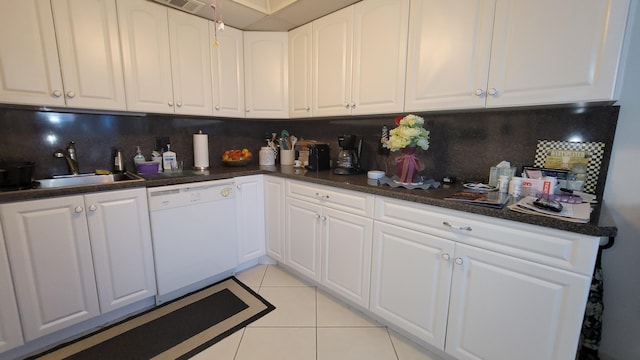 kitchen with sink, white cabinets, white dishwasher, light tile flooring, and tasteful backsplash