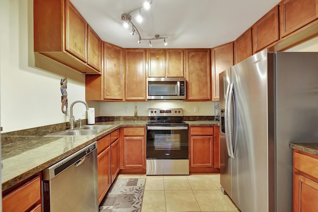 kitchen with sink, light tile patterned floors, and stainless steel appliances