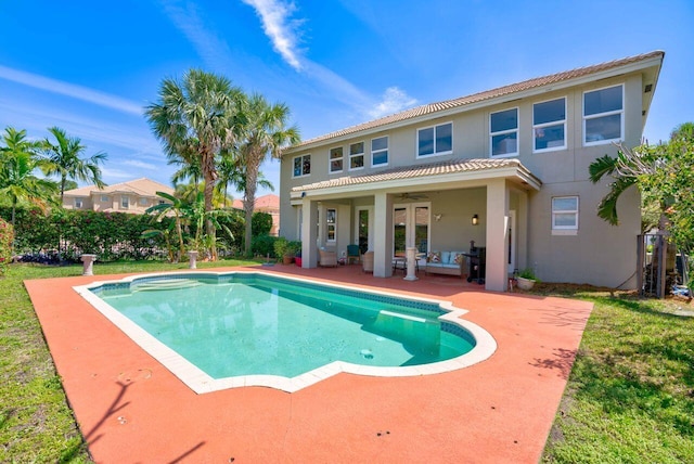 view of pool with outdoor lounge area, a patio, and ceiling fan