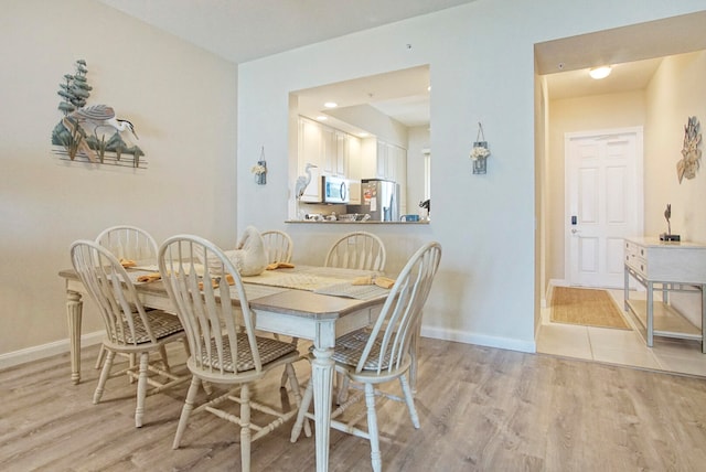 dining room with light hardwood / wood-style floors