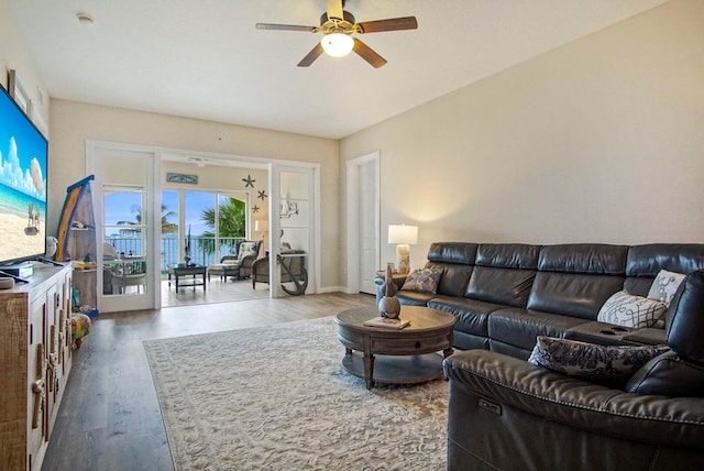 living room with wood-type flooring and ceiling fan