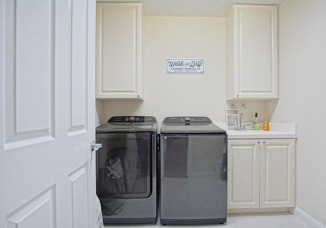 laundry room with cabinets, sink, independent washer and dryer, and light tile patterned flooring