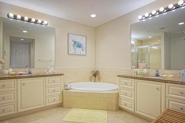 bathroom featuring vanity, shower with separate bathtub, tile patterned flooring, and a textured ceiling