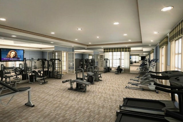 exercise room with crown molding, carpet floors, and a tray ceiling