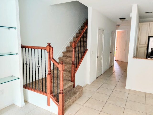 stairway with light tile floors