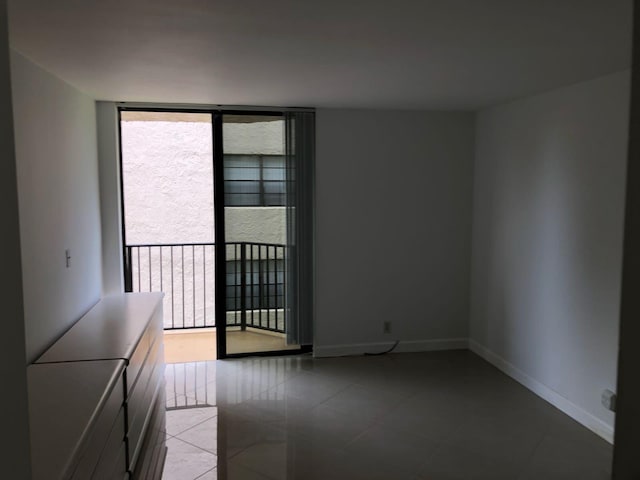 unfurnished room with light tile floors and a wealth of natural light