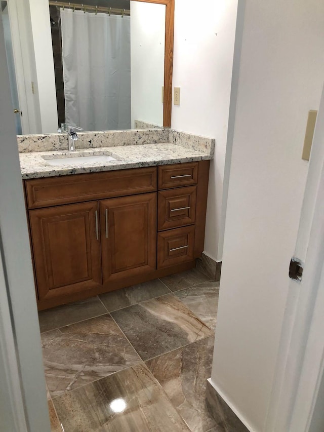 bathroom featuring tile floors and vanity