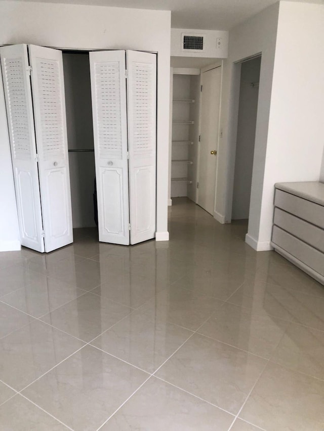 unfurnished bedroom with tile floors