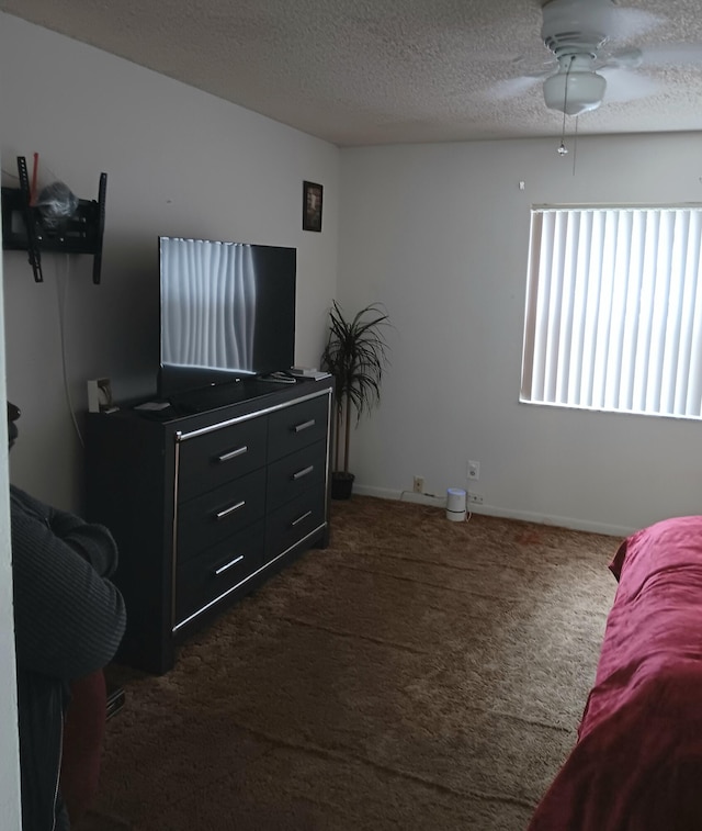 bedroom featuring ceiling fan, carpet, and a textured ceiling