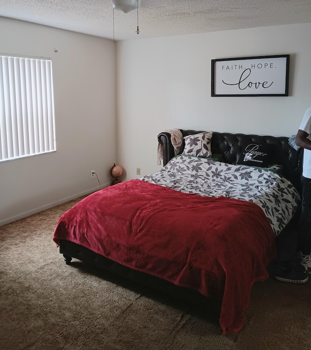 bedroom featuring carpet floors and a textured ceiling