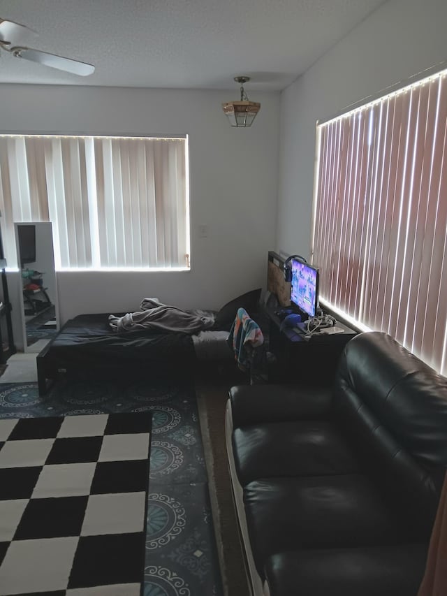 tiled living room with ceiling fan