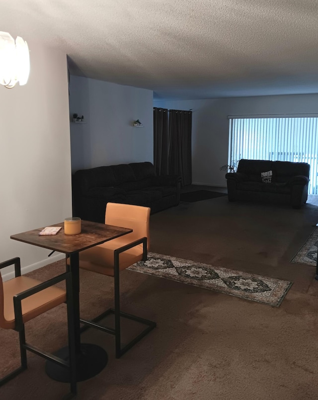 carpeted dining space featuring a textured ceiling