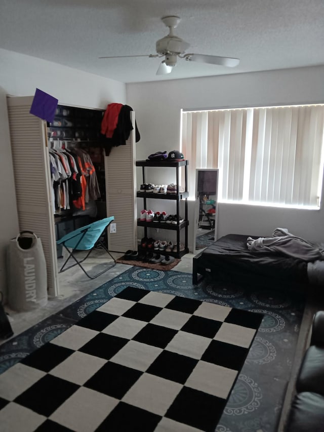 tiled bedroom featuring a closet and ceiling fan