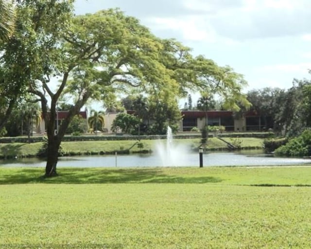 surrounding community featuring a water view and a yard