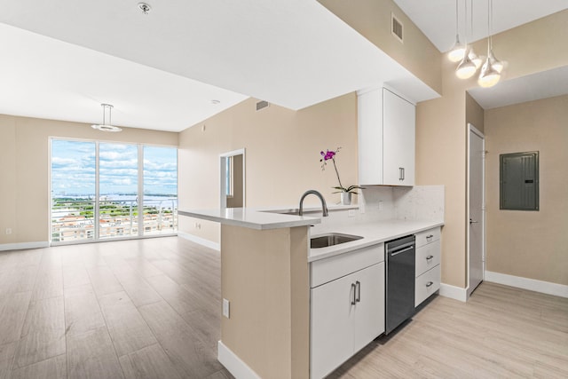 kitchen featuring stainless steel dishwasher, pendant lighting, tasteful backsplash, white cabinetry, and light wood-type flooring