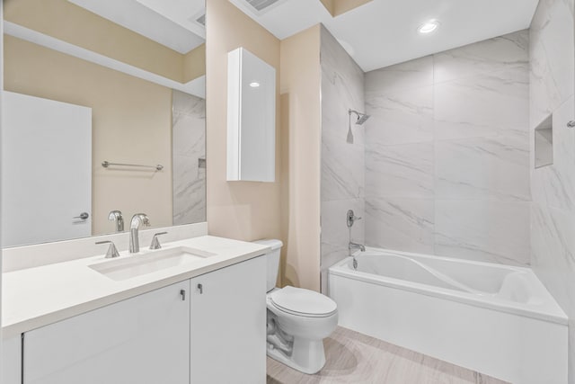 full bathroom with tiled shower / bath combo, toilet, vanity, and tile flooring