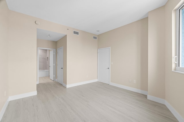 spare room featuring light wood-type flooring