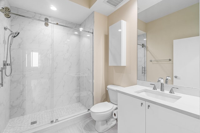 bathroom with a shower with shower door, large vanity, and toilet