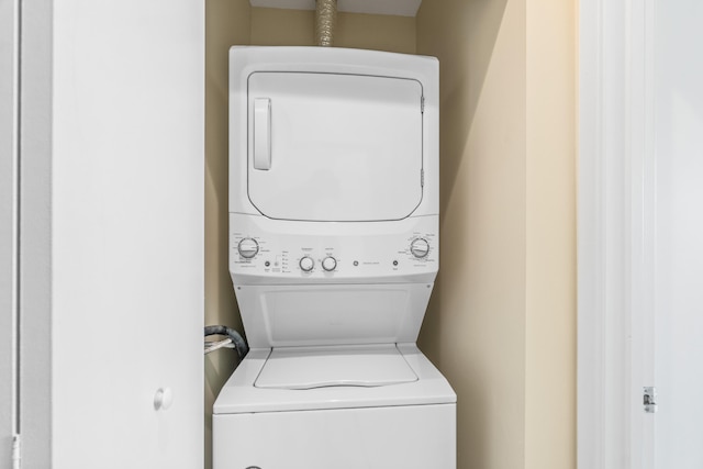 laundry area with stacked washing maching and dryer