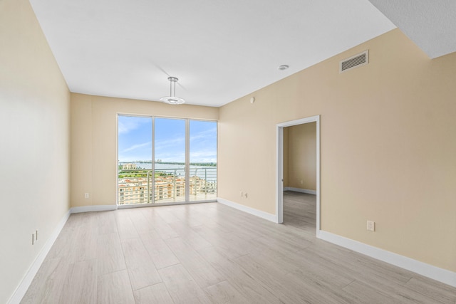 unfurnished room with light hardwood / wood-style floors