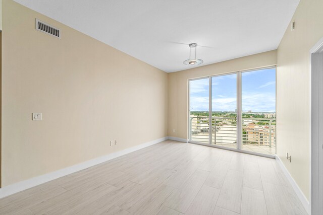 unfurnished room with light wood-type flooring