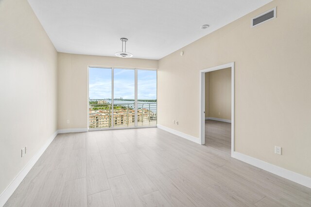 spare room featuring light hardwood / wood-style floors