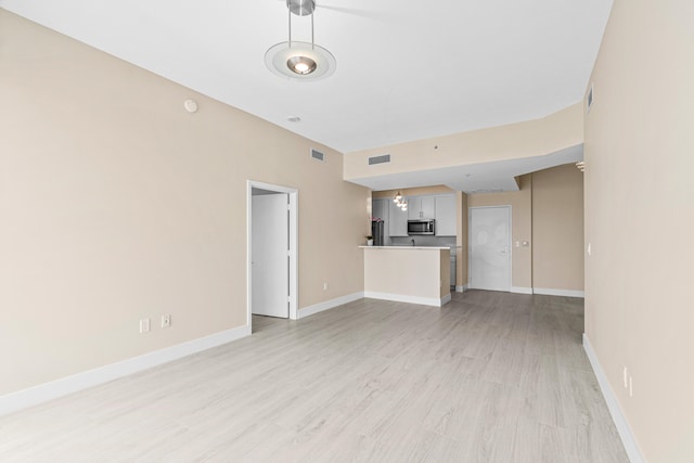 unfurnished living room featuring light wood-type flooring