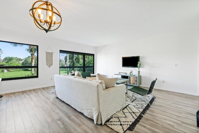 living room featuring an inviting chandelier and light wood-type flooring