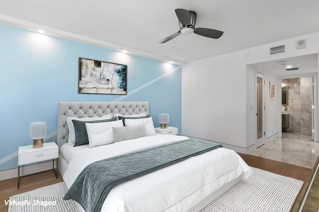 bedroom with light hardwood / wood-style floors, ensuite bath, and ceiling fan