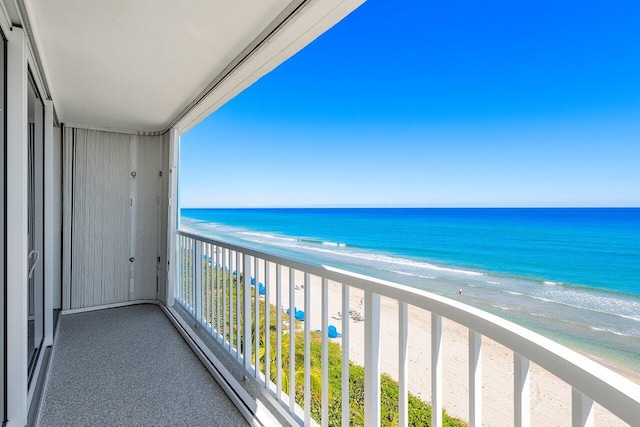 balcony with a beach view and a water view