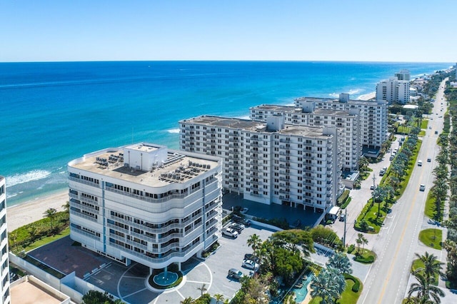 drone / aerial view featuring a water view and a view of the beach