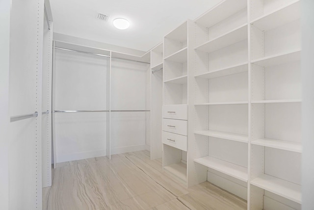 walk in closet featuring light hardwood / wood-style floors