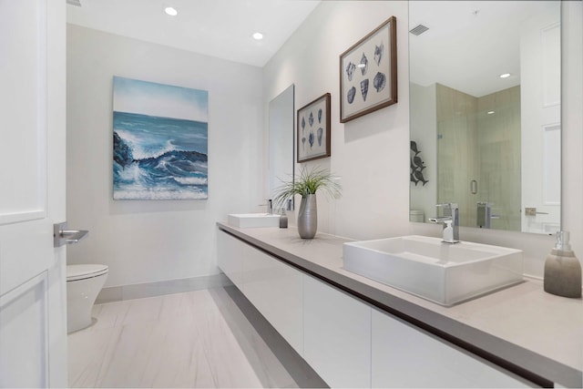 bathroom with walk in shower, vanity, and toilet