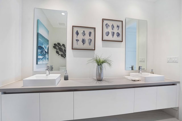 bathroom with toilet and vanity