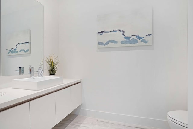 bathroom with toilet and vanity