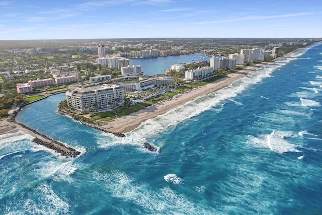 birds eye view of property featuring a beach view and a water view