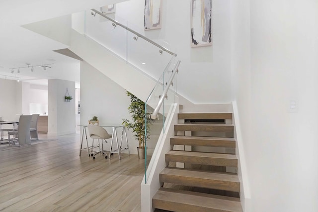 stairs with hardwood / wood-style floors