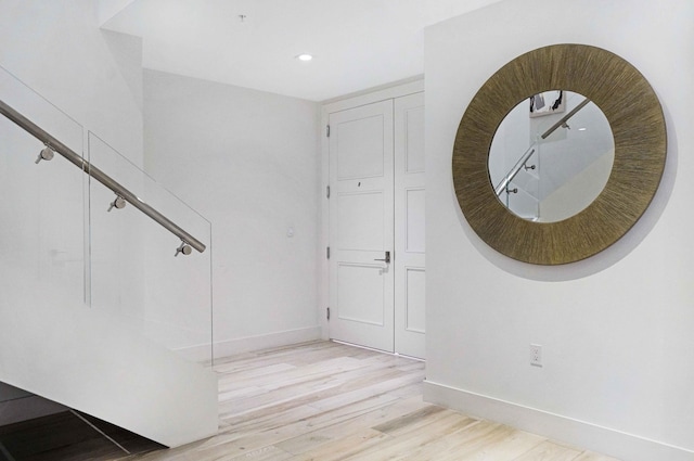 stairway with hardwood / wood-style flooring