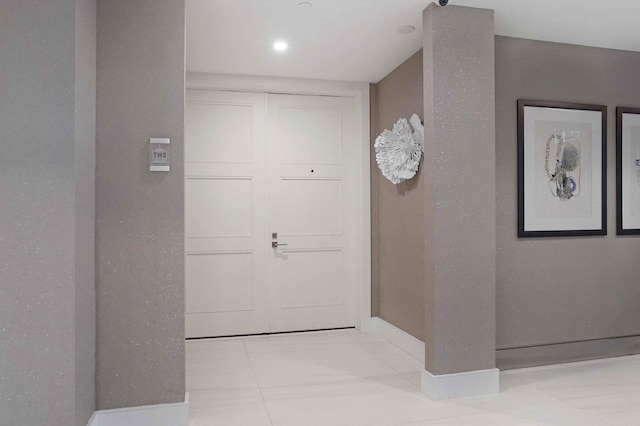 corridor with light tile patterned floors