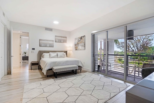 bedroom featuring access to exterior and light hardwood / wood-style flooring