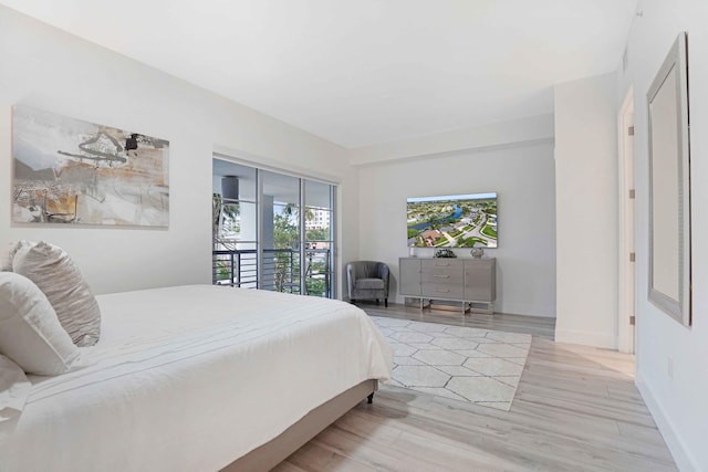 bedroom with light hardwood / wood-style flooring and access to exterior